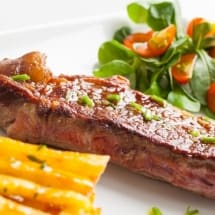 Beef steak with salad and fried chips